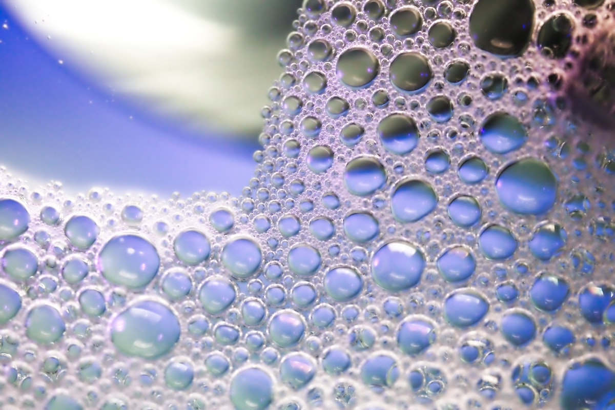 Many soap bubbles on a blue background.